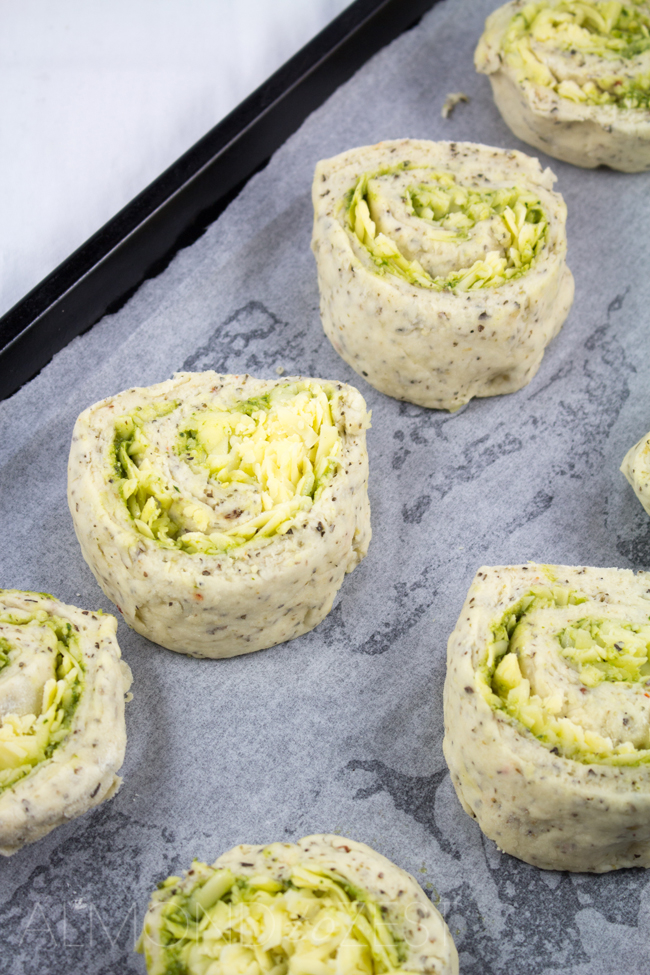 Herby Cheese Pinwheel Scones - Packed with mixed herbs, basil pesto and stuffed with cheese that melts into every crevice! These pinwheel scones are AMAZING!!