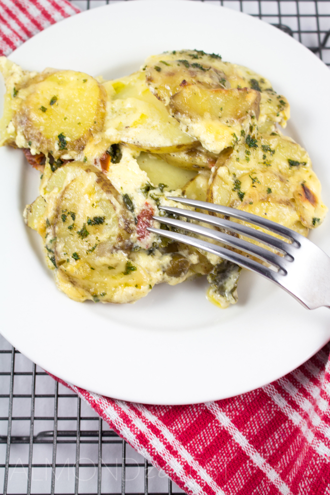 Potato and Ricotta Gratin - Thinly sliced potatoes scattered in layers and drenched in a creamy sauce! Potato and cheesy goodness, a great dinner and vegetarian too!!